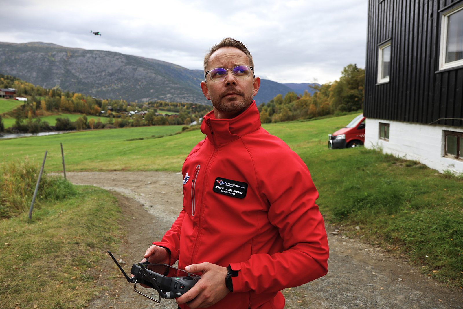 Man looking up to the sky with drone in background